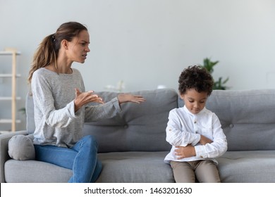 Annoyed Serious Mom Scolding Lecturing Stubborn African Kid Son For Bad Behavior At Home, Angry Parent Mother Punish Little Mixed Race Guilty Child Boy Demand Discipline, Family Conflicts Concept