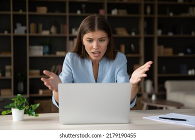 Annoyed stressed businesswoman having problem with laptop, broken or discharged device. Office employee looks at screen, read awful news feels shocked, unexpected app crash, unsaved data, spam concept - Shutterstock ID 2179190455