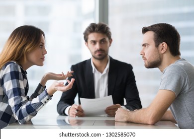 Annoyed unhappy married couple arguing in lawyers office get divorced, angry family spouses split up having disagreement disputing about breaking up and divorce settlement, legal separation concept - Powered by Shutterstock