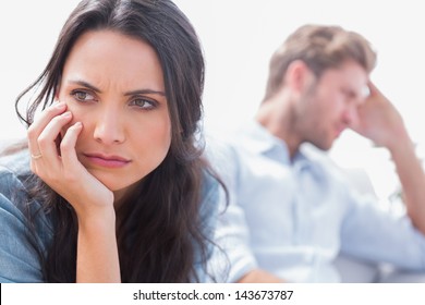 Annoyed Woman Holding Her Head Next To Her Husband