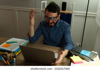 Annoyed Worker Looking Angry And Frustrated While Using The Computer. Workaholic Man Finishing A Deadline Very Late