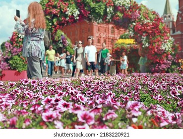 Annual Flower Jam Festival, Manezhnaya Square. Tropical summer in Moscow. Muscovites and tourists take photos on background of designer gardens and flower arrangements. Heatwaves in the city. - Shutterstock ID 2183220921