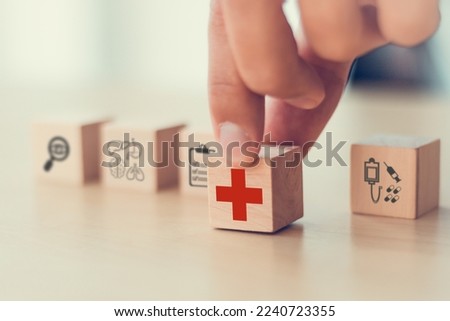 Annual health check, health insurance and medical healthcare. Medical, health and disease concept. Time for medical check up. Putting wooden cube block with red medical cross sign.