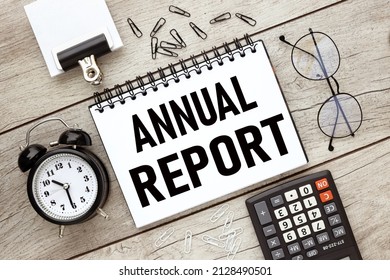 Annual Report, text on open notepad on office wooden table with different stationery calculator. business concept. - Shutterstock ID 2128490501