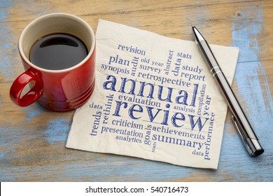 annual review word cloud - handwriting on a napkin with a cup of coffee