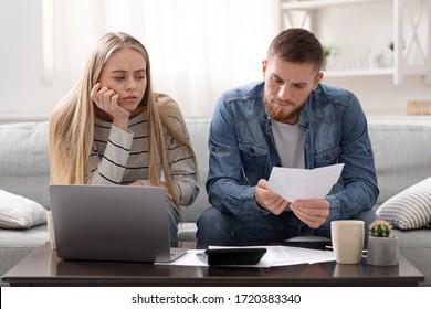 Annual Tax Report. Unhappy Couple Reading Bank Notification, Calculating Budget At Home