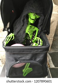 The Annual Zombie Walk To Raise Funds And Gather Food For The Local Food Bank Sees A Skeleton In A Stroller.