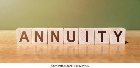 ANNUITY Word Written On Wooden Blocks On Wooden Table. Concept For Your Design.