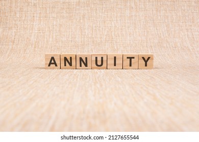 ANNUITY Word Written In Wooden Blocks On Brown Background, Concept