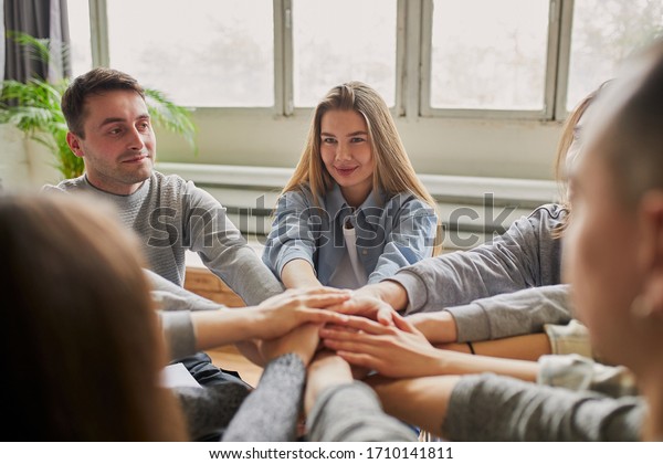 anonymous alcoholics hold hands together, addicts\
take an active role in his own life, struggle for sobriety every\
day and have the willpower to refrain from the temptation to take\
alcohol. team work