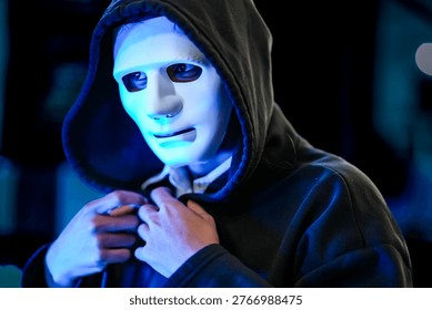 Anonymous black hat hacker executing advanced persistent threat via malware injection. Cybercriminal in mask conducting ransomware attack on digital infrastructure.