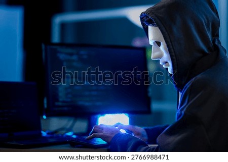 Anonymous black hat hacker executing advanced persistent threat via malware injection. Cybercriminal in mask conducting ransomware attack on digital infrastructure.