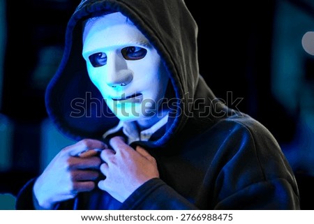 Anonymous black hat hacker executing advanced persistent threat via malware injection. Cybercriminal in mask conducting ransomware attack on digital infrastructure.