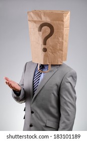 Anonymous Businessman Wearing A Paper Bag On His Head With A Question Mark Concept For  Business Recruitment, Mystery Shopper, Failure Or Embarrassment