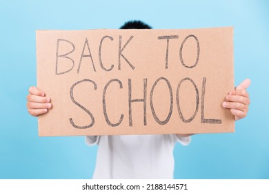 An Anonymous Child Displays A Sign With The Message: 