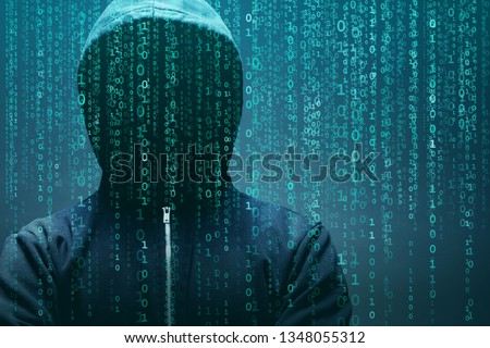 Anonymous computer hacker over abstract digital background. Obscured dark face in mask and hood. Data thief, internet attack, darknet fraud, dangerous viruses and cyber security.