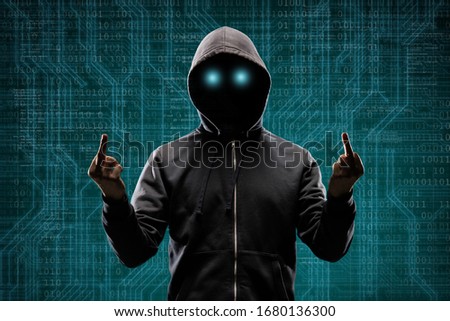 Anonymous computer hacker over abstract digital background. Obscured dark face in mask and hood. Data thief, internet attack, darknet fraud, dangerous viruses and cyber security .