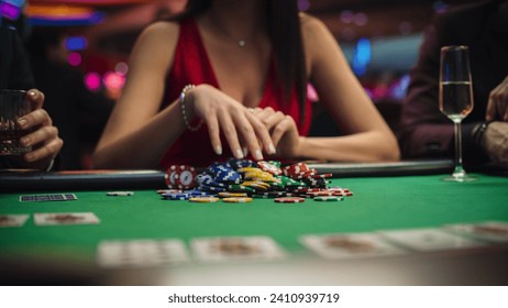 Anonymous Glamorous Woman in a Evening Dress Collecting her Prize of Poker Chips in a Luxury Casino. Lucky Female Winner Hitting the Jackpot, Happy and Rich - Powered by Shutterstock