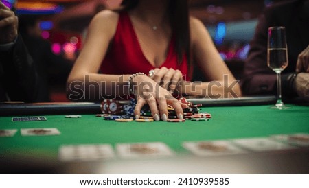 Anonymous Glamorous Woman in a Evening Dress Collecting her Prize of Poker Chips in a Luxury Casino. Lucky Female Winner Hitting the Jackpot, Happy and Rich.