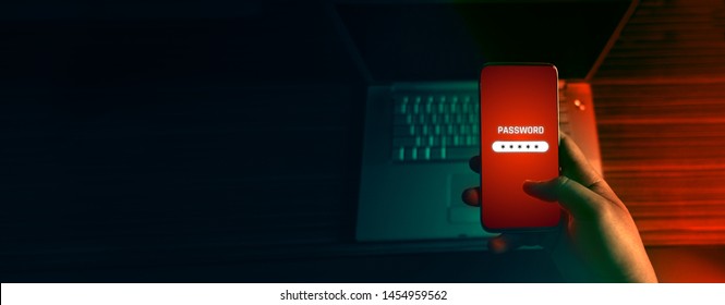 An anonymous hacker and uses a malware with mobile phone to hack password the personal data and money from Bank accounts. The concept of cyber crime. - Shutterstock ID 1454959562