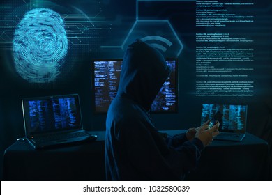 An Anonymous Hacker Without A Face Uses A Mobile Phone To Hack The System. Stealing Personal Data And Money From Bank Accounts. The Concept Of Cyber Crime And Hacking Electronic Devices