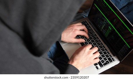 Anonymous Hooded Hacker Programming in Computer Console Breaking Password