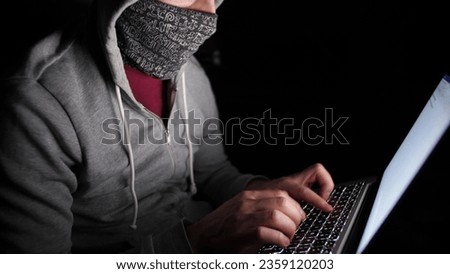 Anonymous Hooded Hacker Programming in Computer Console Breaking Password