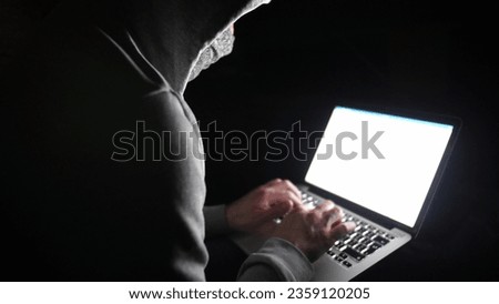 Anonymous Hooded Hacker Programming in Computer Console Breaking Password
