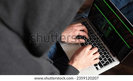 Anonymous Hooded Hacker Programming in Computer Console Breaking Password