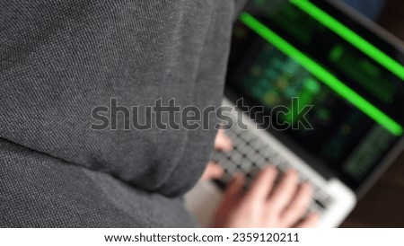 Anonymous Hooded Hacker Programming in Computer Console Breaking Password