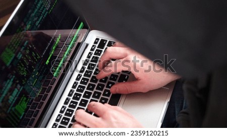 Anonymous Hooded Hacker Programming in Computer Console Breaking Password