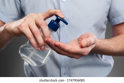 Anonymous male in shirt applying antibacterial soap on hands during hygienic routine in coronavirus pandemic - Shutterstock ID 1747906085