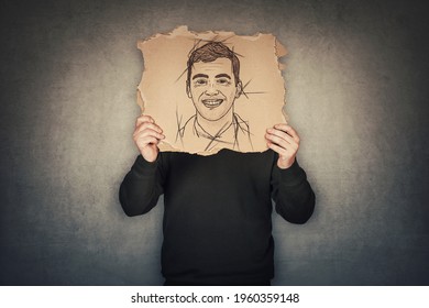 Anonymous Man Covers His Head With A Fake Mask, Hiding Emotions Behind A Torn Cardboard Sheet With Another Face Expression Sketch Drawing. Incognito Person Wanted. Introvert Person, Hidden Identity