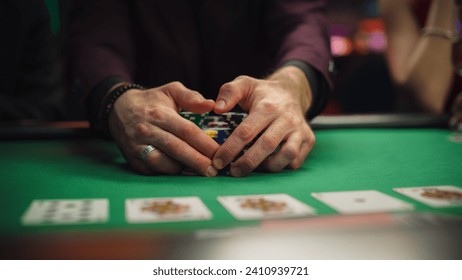 Anonymous Man Dressed in Suit Collecting his Prize of Poker Chips in a Modern Casino. Lucky Male Winner Hitting the Jackpot, Happy About His Risky Bet that Paid of Handsomely