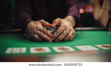 Anonymous Man Dressed in Suit Collecting his Prize of Poker Chips in a Modern Casino. Lucky Male Winner Hitting the Jackpot, Happy About His Risky Bet that Paid of Handsomely