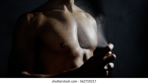 Anonymous Man Spraying Fragrance In Extreme Slow Motion, With Scent Particles To Wet Skin After Showering.