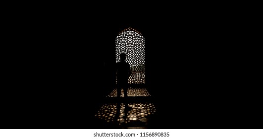 Anonymous man standing in a lightframe