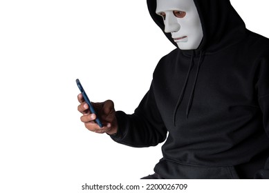 Anonymous Masked Hacker Is Using Smartphones To Penetrate Financial Data With Clipping Path, Hacking And Malware Concept.