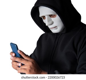 Anonymous Masked Hacker Is Using Smartphones To Penetrate Financial Data With Clipping Path, Hacking And Malware Concept.