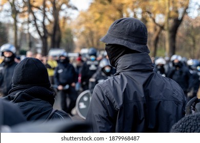 Anonymous Masked Left Wing Antifa, Or So Called Black Block Is Standing In Front Of A Riot Police Line With Helmets On In Germany To Block Other Protesters.