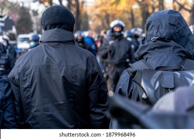 Anonymous Masked Left Wing Antifa, Or So Called Black Block Is Standing In Front Of A Riot Police Line With Helmets On In Germany To Block Other Protesters.