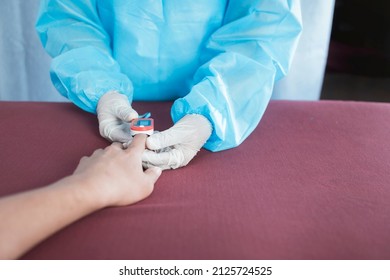 An Anonymous Nurse Inserts An Oximeter On A Patient's Index Finger. Checking Blood Oxygen Or SpO2 Levels. At The Emergency Ward Of A Hospital.