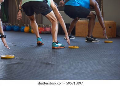 Anonymous people reaching lunging in gym as they run fast short sprints in gym - Shutterstock ID 595715897