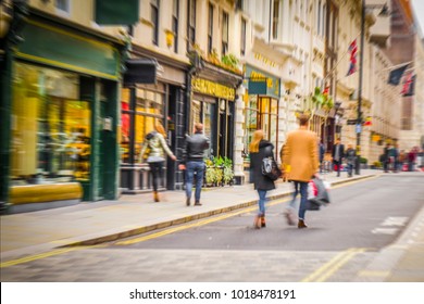 Anonymous People Walking Down High Street Holding Shopping Bags