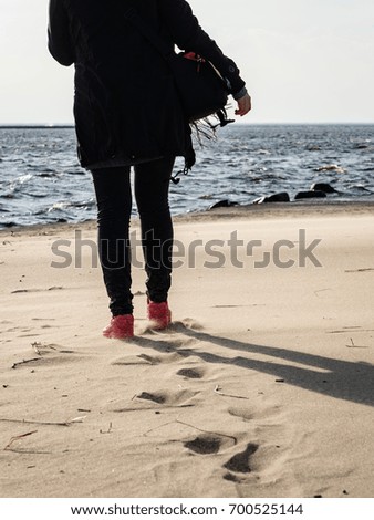 Similar – Image, Stock Photo Young woman with pipe backlit by the sea in the midnight sun