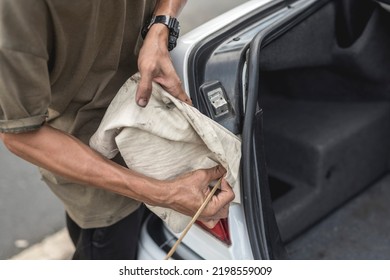 Anonymous Photo Of A Mechanic Cleaning The Grooves Of The Car Trunk Rubber Weatherstripping With A Stick Wrapped With Microfiber Towel. At A Auto Repair Shop.