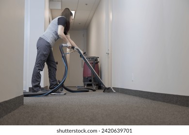 anonymous professional cleaner using a carpet extractor