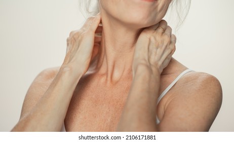 Anonymous Senior Woman Touching Her Neck, Chest, With Sensual Movement Of Hands, Enjoying Soft Skin. Elderly Female Natural Beauty. Dignity And Grace In Old Age. Concept For Skin Care, Healthy Living