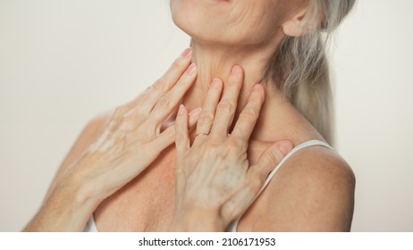 Anonymous Senior Woman Touching Her Neck, Chest, With Hands, Enjoying Soft Skin. Elderly Female Natural Beauty. Dignity And Grace In Old Age. Isolated Background For Skin Care, Healthy Living Concept