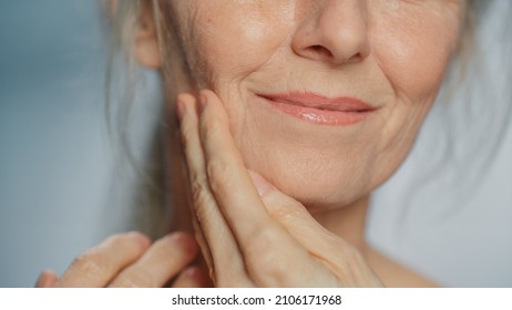 Anonymous Senior Woman Touching Her Neck, Chest, With Sensual Movement Of Hands, Enjoying Soft Skin. Elderly Female Natural Beauty. Dignity And Grace In Old Age. Concept For Skin Care, Healthy Living